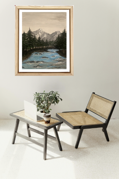 mountain riverside painting in a black frame