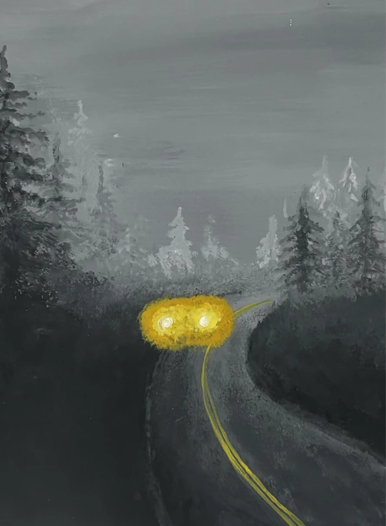 foggy road with yellow glowing car lights